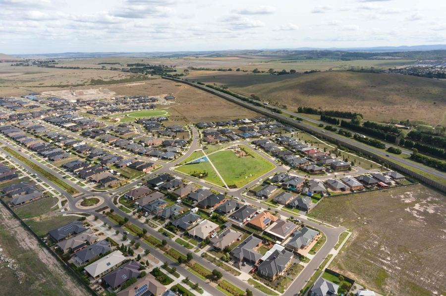 Aerial view of a new residential housing estate in Beveridge, bordered by open rural land